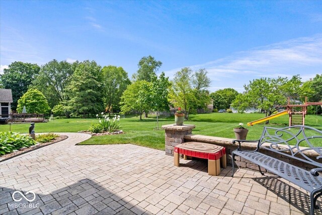 12082 Old Stone Dr, Indianapolis, IN 46236 - view of patio featuring a playground and view of wooded area