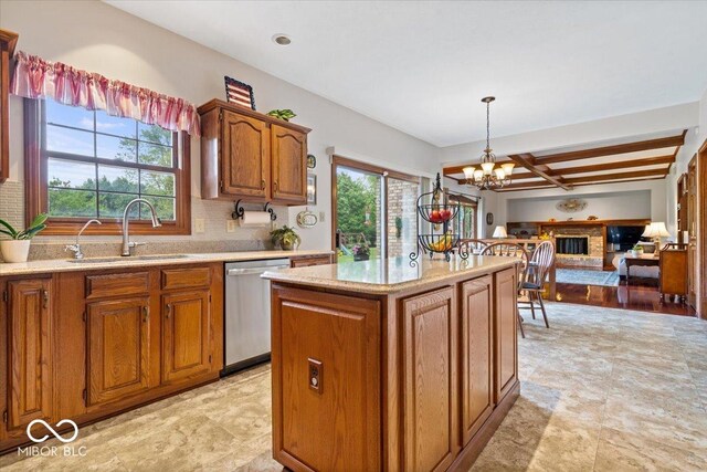 12082 Old Stone Dr, Indianapolis, IN 46236 - kitchen featuring a sink, stainless steel dishwasher, a chandelier, brown cabinets, and a center island