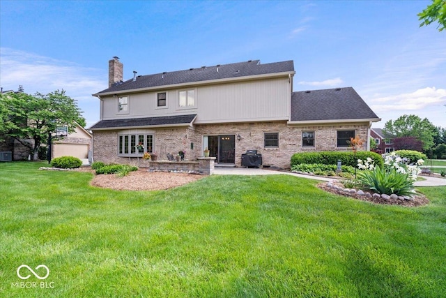 12082 Old Stone Dr, Indianapolis, IN 46236 - rear view of house with a chimney, a yard, a patio area, and brick siding