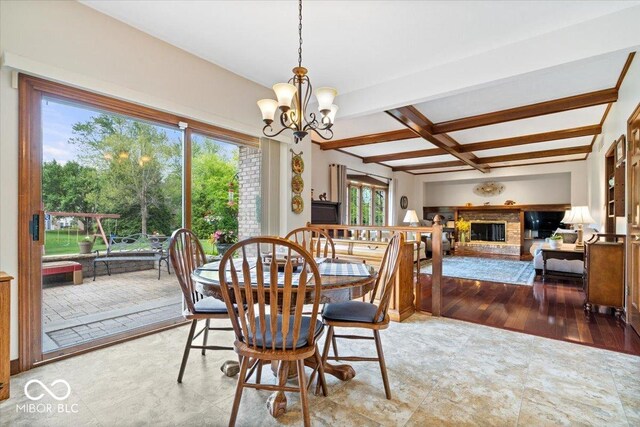 12082 Old Stone Dr, Indianapolis, IN 46236 - dining room featuring a chandelier, beam ceiling, a fireplace, coffered ceiling, and wood finished floors