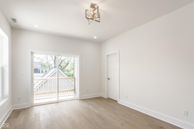 39 N Walcott St, Indianapolis, IN 46201 - spare room with a chandelier, light wood-style floors, baseboards, and recessed lighting