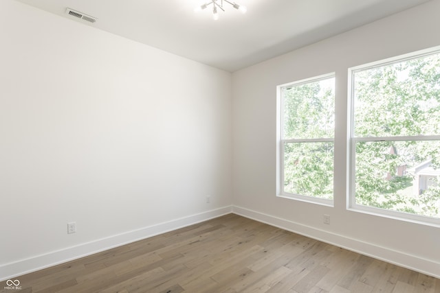 39 N Walcott St, Indianapolis, IN 46201 - spare room with baseboards, light wood finished floors, and healthy amount of natural light