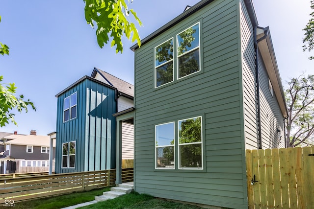 39 N Walcott St, Indianapolis, IN 46201 - rear view of house with fence and board and batten siding