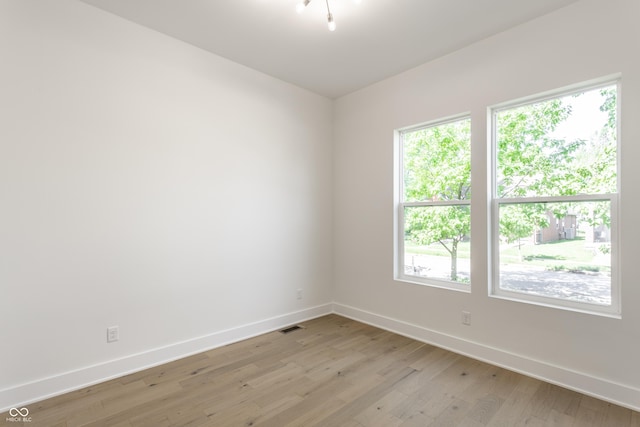 39 N Walcott St, Indianapolis, IN 46201 - spare room featuring baseboards, light wood finished floors, and healthy amount of natural light