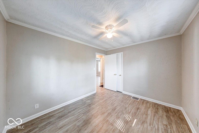1852 N Warman Ave, Indianapolis, IN 46222 - spare room featuring ornamental molding, ceiling fan, and wood finished floors