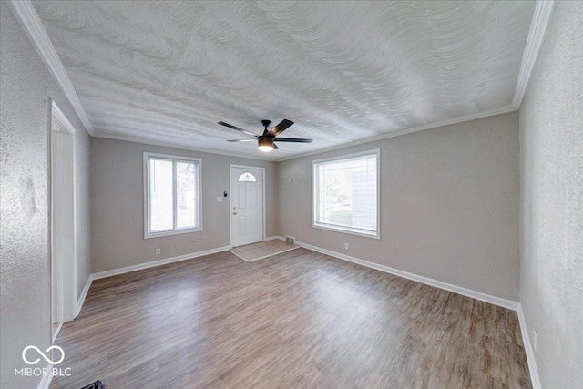 1852 N Warman Ave, Indianapolis, IN 46222 - entryway with ornamental molding, plenty of natural light, wood finished floors, a ceiling fan, and a textured wall