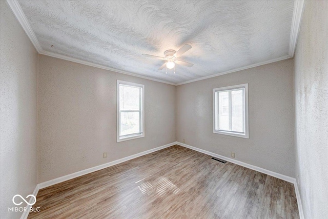 1852 N Warman Ave, Indianapolis, IN 46222 - unfurnished room featuring ornamental molding, ceiling fan, light wood-style floors, and a textured ceiling