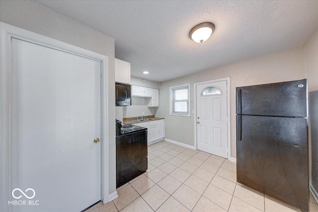 1852 N Warman Ave, Indianapolis, IN 46222 - kitchen featuring freestanding refrigerator, electric range oven, white cabinets, stainless steel microwave, and light tile patterned floors