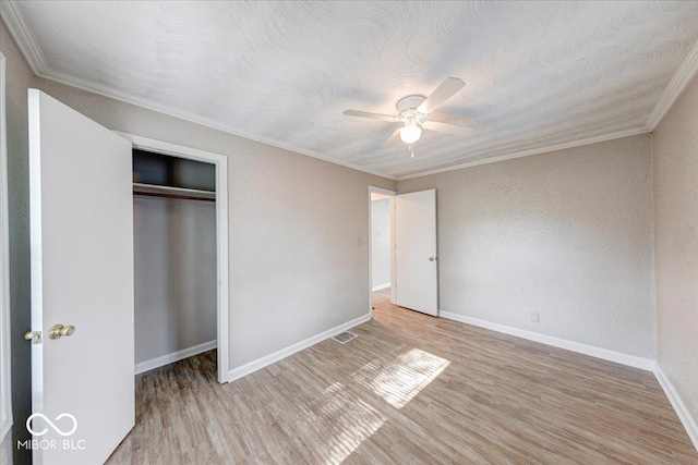 1852 N Warman Ave, Indianapolis, IN 46222 - unfurnished bedroom featuring wood finished floors, ornamental molding, a closet, and a ceiling fan