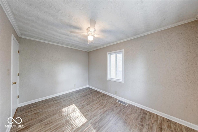 1852 N Warman Ave, Indianapolis, IN 46222 - spare room featuring ornamental molding, a ceiling fan, and wood finished floors