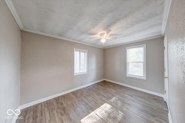 1852 N Warman Ave, Indianapolis, IN 46222 - unfurnished room with ornamental molding, a ceiling fan, wood finished floors, a textured ceiling, and a textured wall