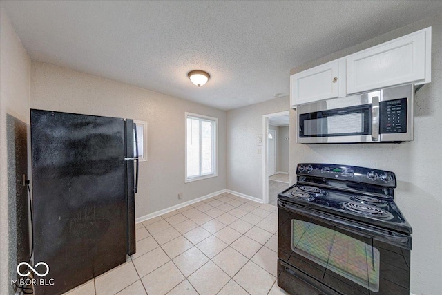 1852 N Warman Ave, Indianapolis, IN 46222 - kitchen with black appliances, white cabinets, light tile patterned floors, and a textured ceiling