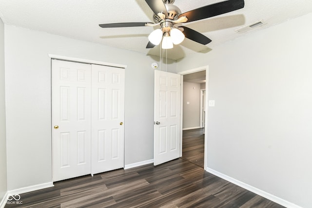 9676 W Constellation Dr, Pendleton, IN 46064 - unfurnished bedroom with dark wood-type flooring, baseboards, a closet, and ceiling fan