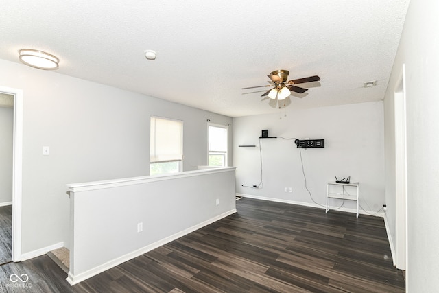 9676 W Constellation Dr, Pendleton, IN 46064 - spare room featuring dark wood finished floors, a ceiling fan, a textured ceiling, and baseboards