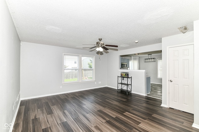 9676 W Constellation Dr, Pendleton, IN 46064 - unfurnished living room with dark wood finished floors, a ceiling fan, a textured ceiling, and baseboards