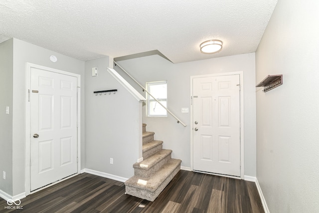 9676 W Constellation Dr, Pendleton, IN 46064 - entryway featuring dark wood finished floors, stairway, baseboards, and a textured ceiling