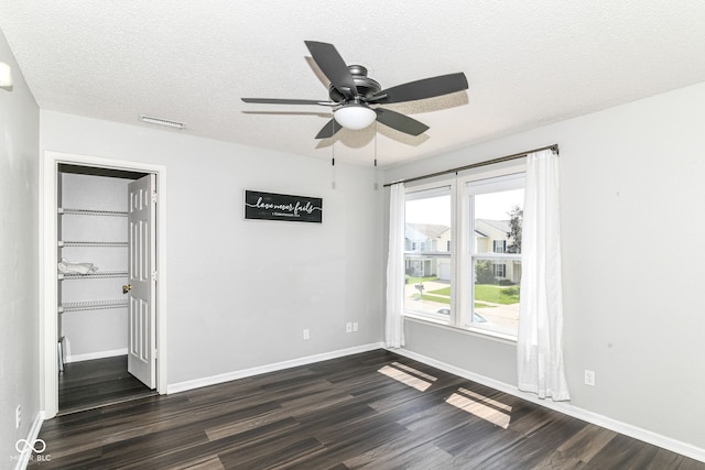 9676 W Constellation Dr, Pendleton, IN 46064 - unfurnished bedroom with dark wood-style flooring, a textured ceiling, baseboards, and a ceiling fan