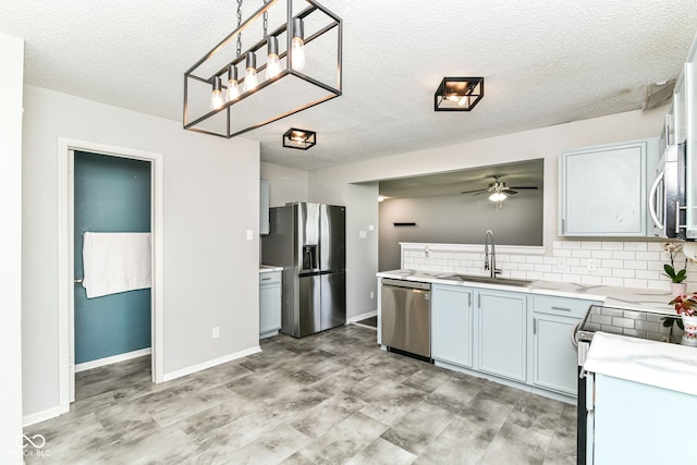 9676 W Constellation Dr, Pendleton, IN 46064 - kitchen featuring a sink, stainless steel appliances, ceiling fan, light countertops, and a textured ceiling