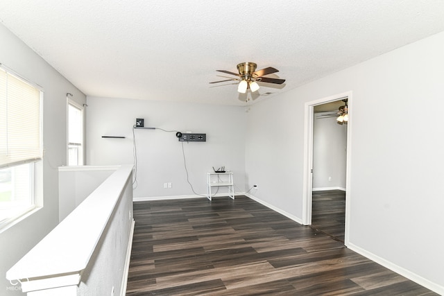 9676 W Constellation Dr, Pendleton, IN 46064 - spare room featuring a ceiling fan, dark wood-style floors, a textured ceiling, and baseboards