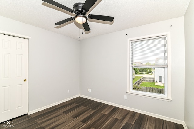 9676 W Constellation Dr, Pendleton, IN 46064 - unfurnished room featuring dark wood-style flooring, baseboards, a ceiling fan, and a textured ceiling