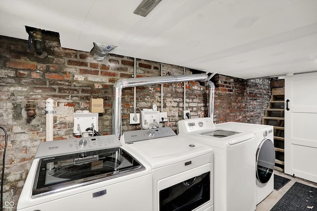 847 N Park Ave, Indianapolis, IN 46202 - laundry room with separate washer and dryer and brick wall