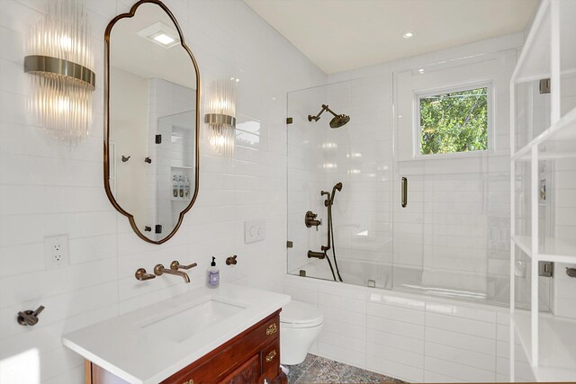 847 N Park Ave, Indianapolis, IN 46202 - bathroom featuring tiled shower / bath, vanity, toilet, and tile walls