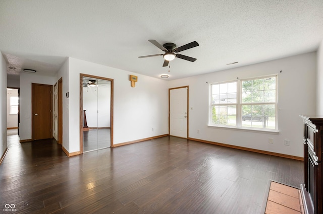 6715 Wandering Way, Indianapolis, IN 46241 - unfurnished living room with ceiling fan, wood finished floors, baseboards, and a textured ceiling
