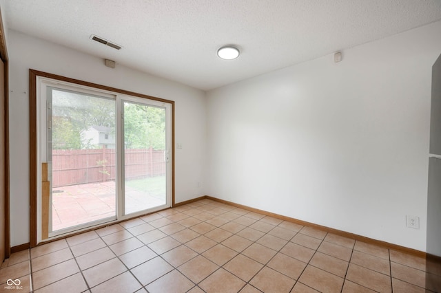 6715 Wandering Way, Indianapolis, IN 46241 - unfurnished room with a textured ceiling, baseboards, and light tile patterned floors