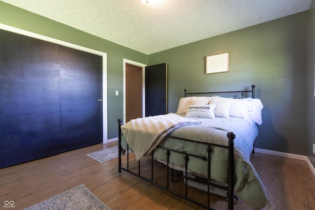 6310 E County Road 200 S, Butlerville, IN 47223 - bedroom with wood finished floors and a textured ceiling