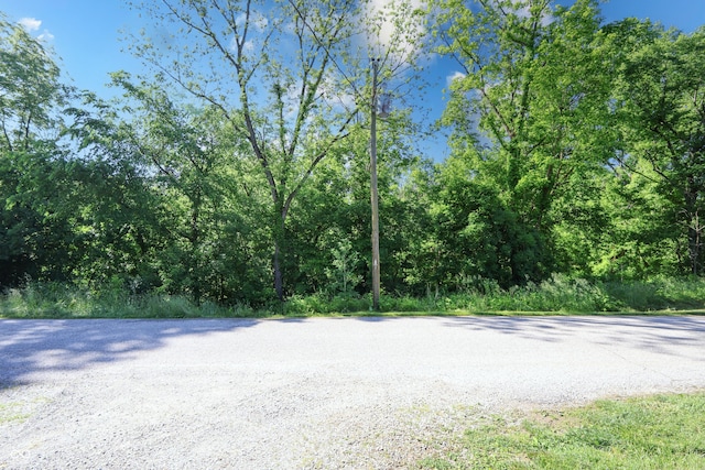 6310 E County Road 200 S, Butlerville, IN 47223 - view of asphalt road featuring a forest view