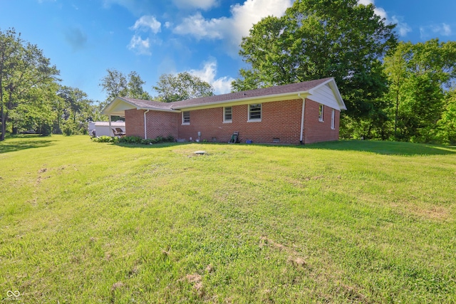 6310 E County Road 200 S, Butlerville, IN 47223 - rear view of property featuring a lawn, brick siding, and crawl space