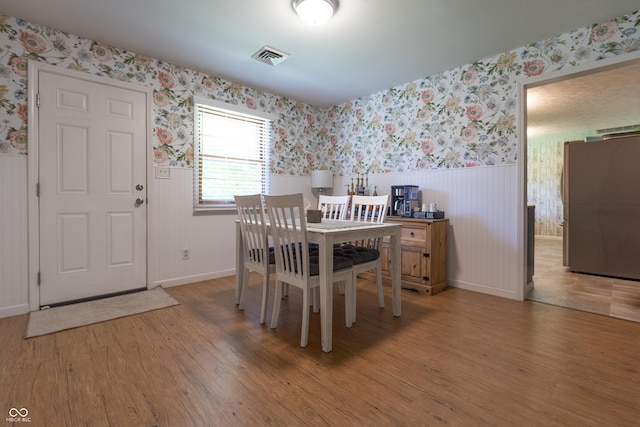 6310 E County Road 200 S, Butlerville, IN 47223 - dining room with wallpapered walls, a wainscoted wall, and wood finished floors