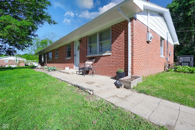 6310 E County Road 200 S, Butlerville, IN 47223 - view of side of property with brick siding, a lawn, and a patio