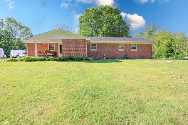 6310 E County Road 200 S, Butlerville, IN 47223 - rear view of house featuring a yard and brick siding