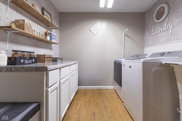 6310 E County Road 200 S, Butlerville, IN 47223 - laundry area with washing machine and dryer, light wood-style flooring, and cabinet space