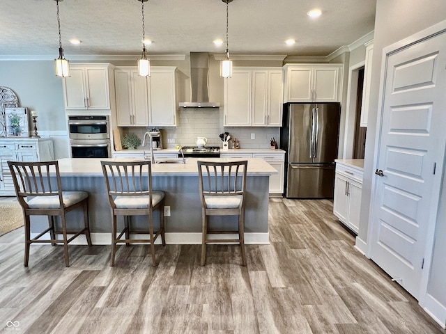 3691 Talmine Ln, Bargersville, IN 46106 - kitchen featuring appliances with stainless steel finishes, wall chimney range hood, crown molding, light countertops, and wood finished floors