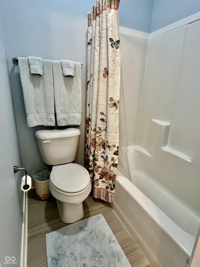 3691 Talmine Ln, Bargersville, IN 46106 - bathroom featuring wood finished floors, toilet, shower / bath combination with curtain, and baseboards