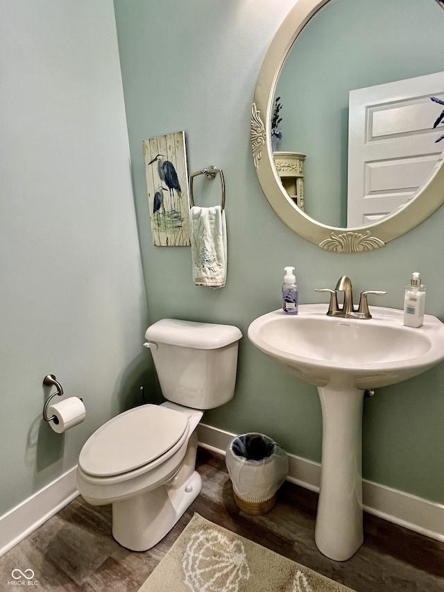 3691 Talmine Ln, Bargersville, IN 46106 - half bathroom featuring toilet, baseboards, a sink, and wood finished floors