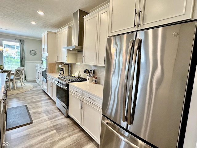 3691 Talmine Ln, Bargersville, IN 46106 - kitchen featuring stainless steel appliances, wall chimney exhaust hood, light countertops, recessed lighting, and light wood-type flooring