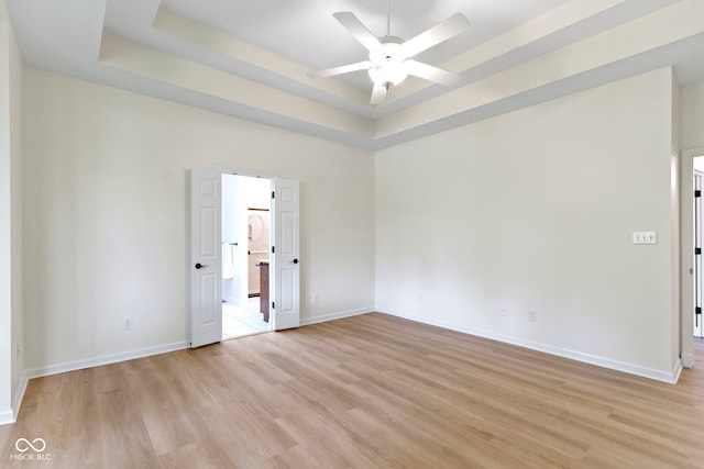 1941 Orchard Ct, Carmel, IN 46280 - unfurnished room with ceiling fan, light wood-style flooring, a tray ceiling, and baseboards