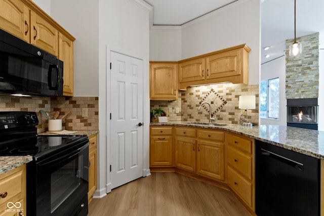 1941 Orchard Ct, Carmel, IN 46280 - kitchen with black appliances, light wood-style flooring, a sink, light stone counters, and ornamental molding