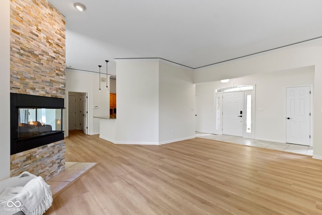 1941 Orchard Ct, Carmel, IN 46280 - unfurnished living room with light wood-type flooring, a fireplace, and baseboards