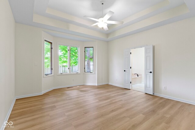 1941 Orchard Ct, Carmel, IN 46280 - empty room featuring a raised ceiling, a ceiling fan, light wood finished floors, and baseboards