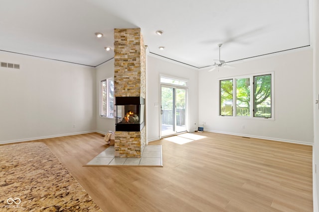 1941 Orchard Ct, Carmel, IN 46280 - unfurnished living room featuring light wood-style flooring, a fireplace, crown molding, ceiling fan, and baseboards
