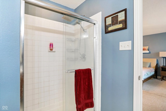 bathroom with a shower stall and connected bathroom