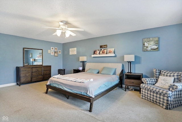 carpeted bedroom featuring ceiling fan and baseboards