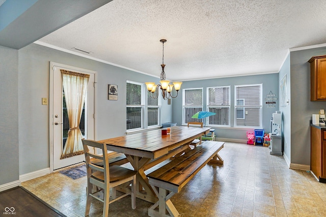 dining space featuring a chandelier, baseboards, crown molding, and a textured ceiling