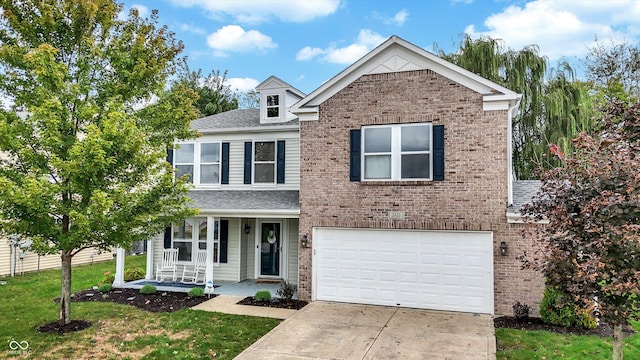 traditional-style home featuring a porch, concrete driveway, brick siding, and a garage