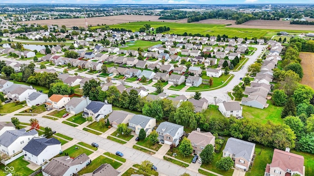 aerial view of property and surrounding area with nearby suburban area