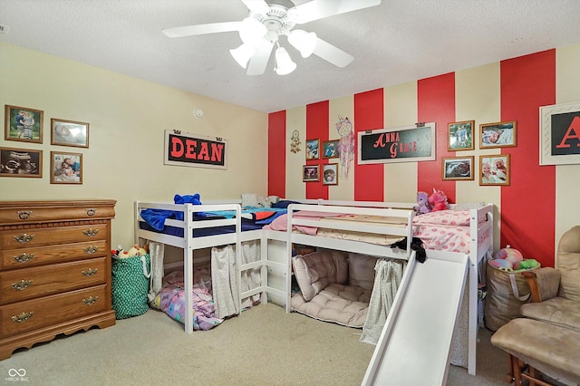 bedroom featuring carpet, a textured ceiling, and ceiling fan